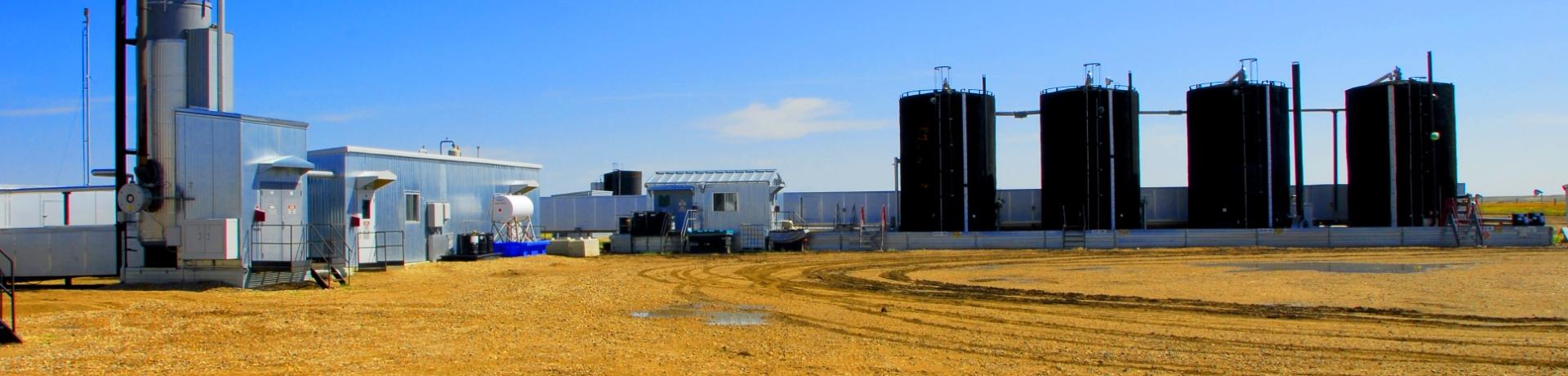 Farm field with oil machinery 